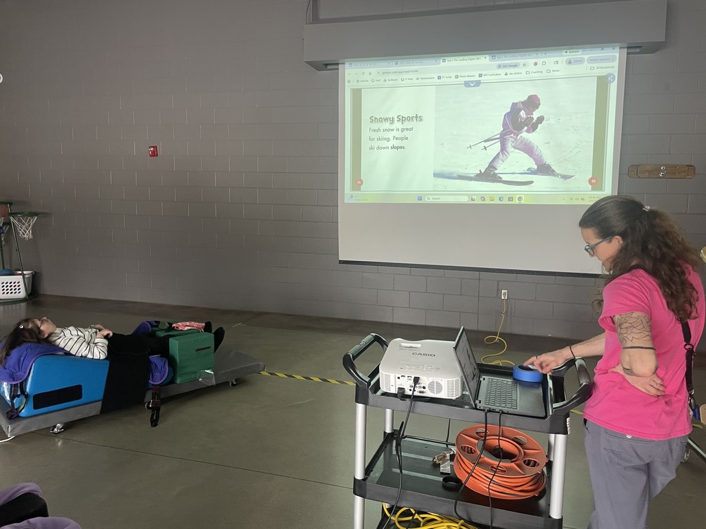 Teacher read a book from the board.