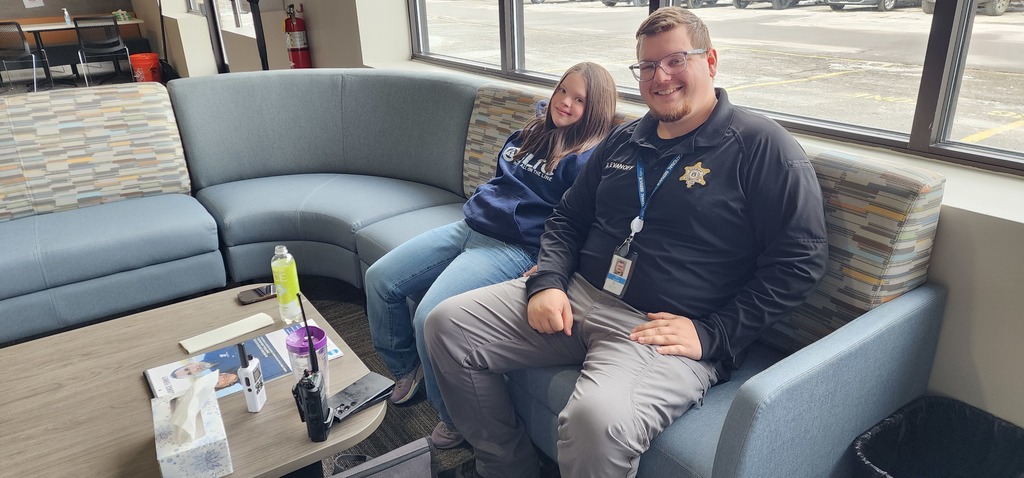 A male Officer sitting next to female leaner.