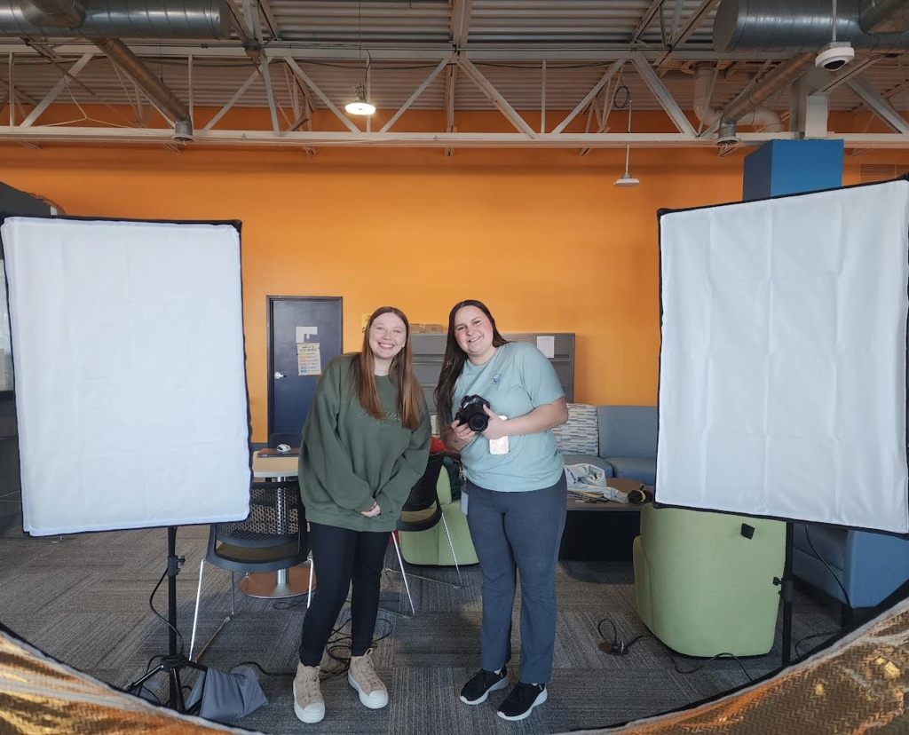 Two young ladies posing for a photo.