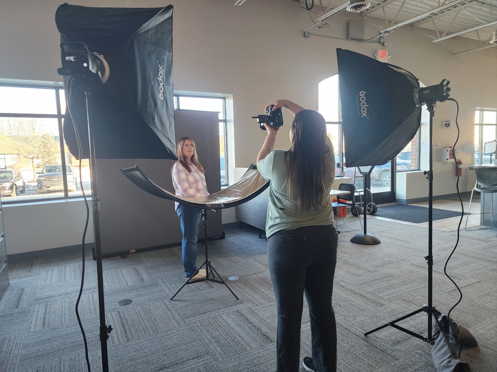 A young lady taking a photo of another lady.