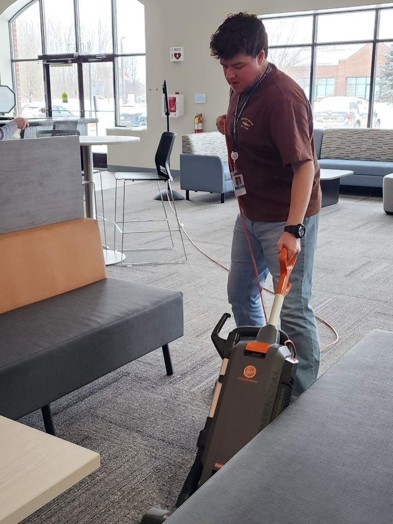 Young adult vacuuming.