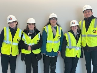 Group of people in safety vests and hard hats