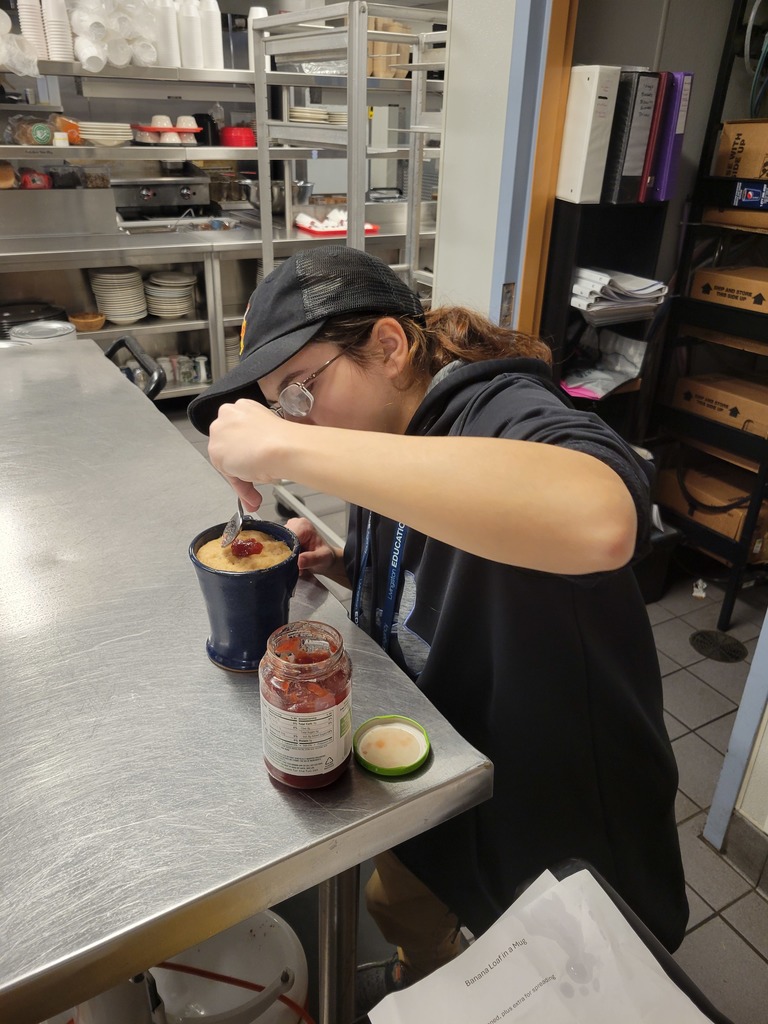 Person putting Jelly into a cup 
