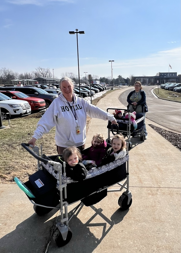 Woman with kids in a wagon.