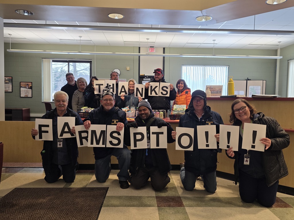 Group photo saying thank you spelled out with signs