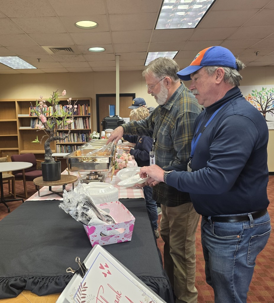 Men in line for a breakfast buffet