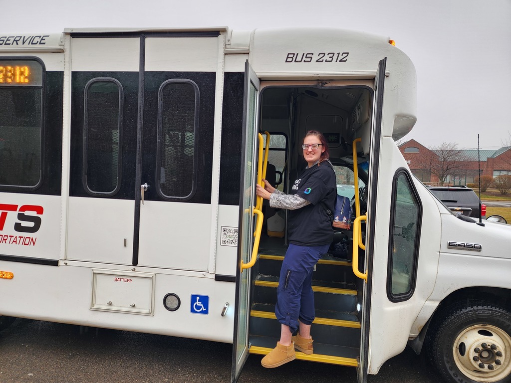 Young adult women stepping up into a public transportation bus.