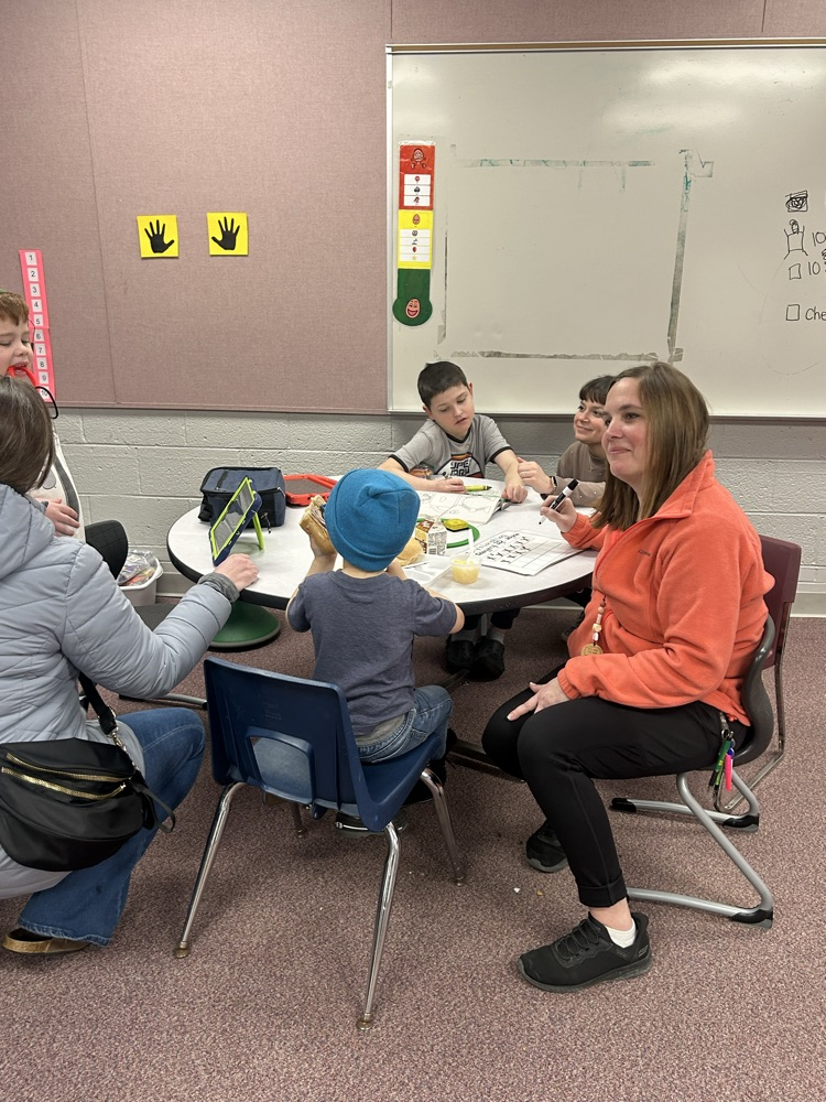 students and staff sitting at table