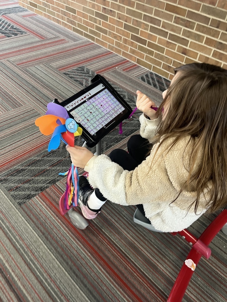 Overhead image of a student on a bike with AAC mounted on the handlebars. 