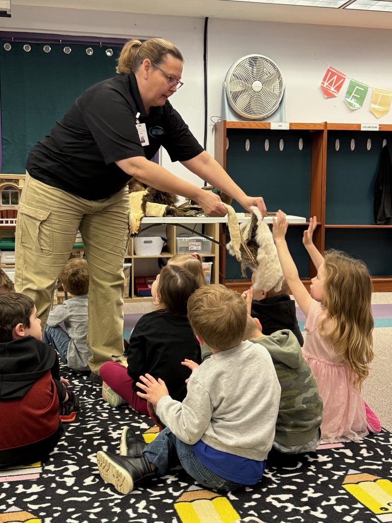 Preschool children participating in a classroom presentation from Kensington Metropark, exploring animal furs.