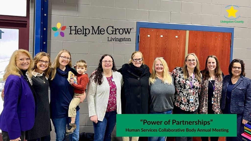 Nine women standing in a line shoulder to shoulder
