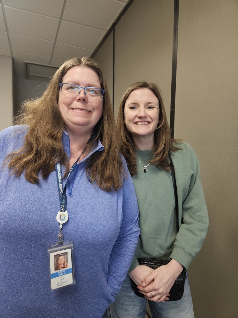 Two ladies smiling at the camera