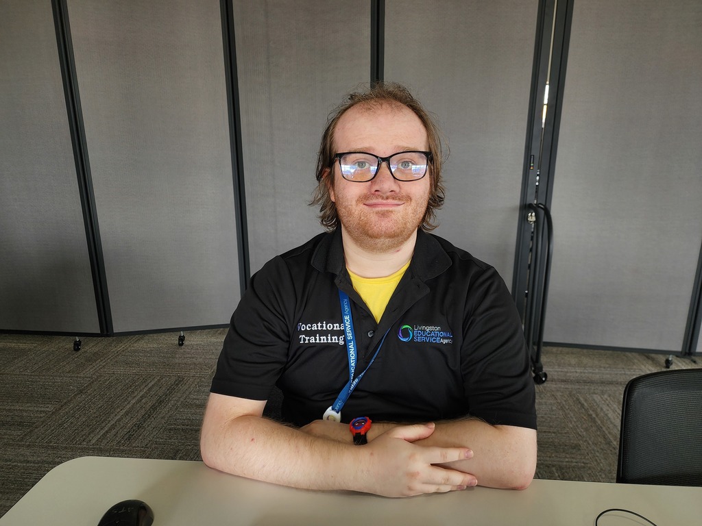A young man sitting at a desk.