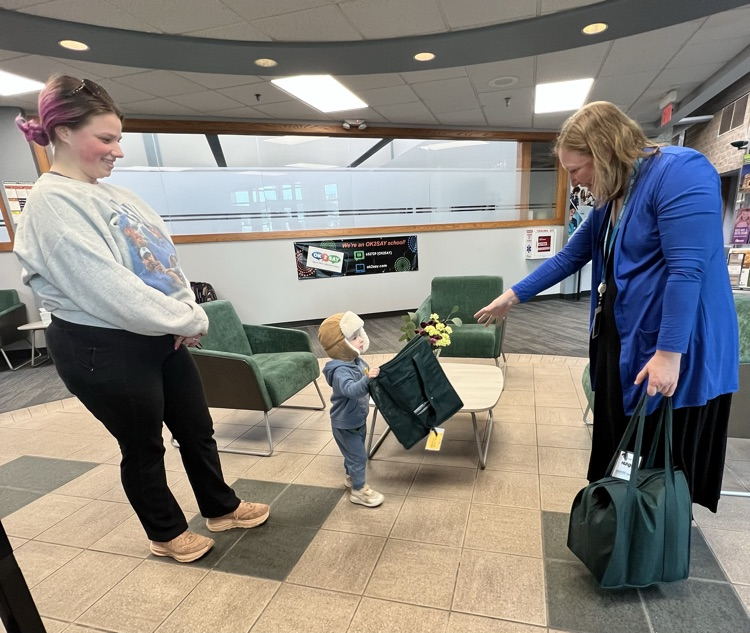 Two women and a little boy stand in a lobby. 