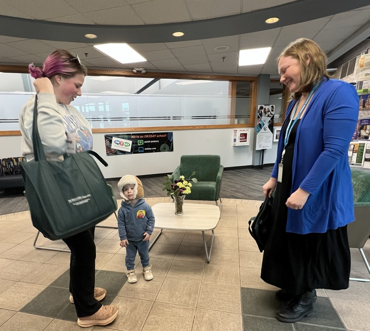 Two women and a little boy stand in a lobby. 