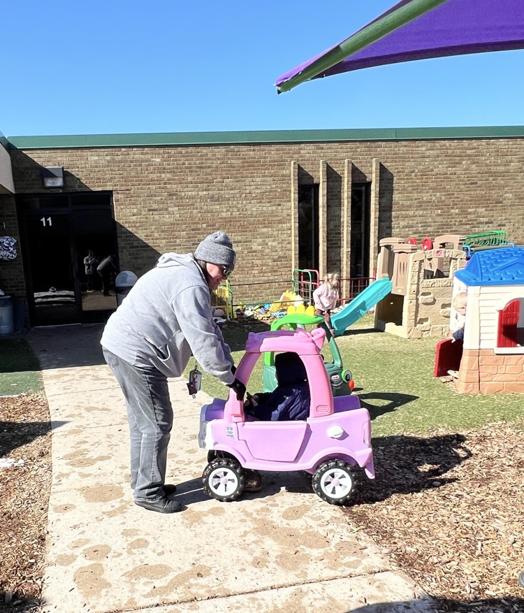 Women helping child with toy car