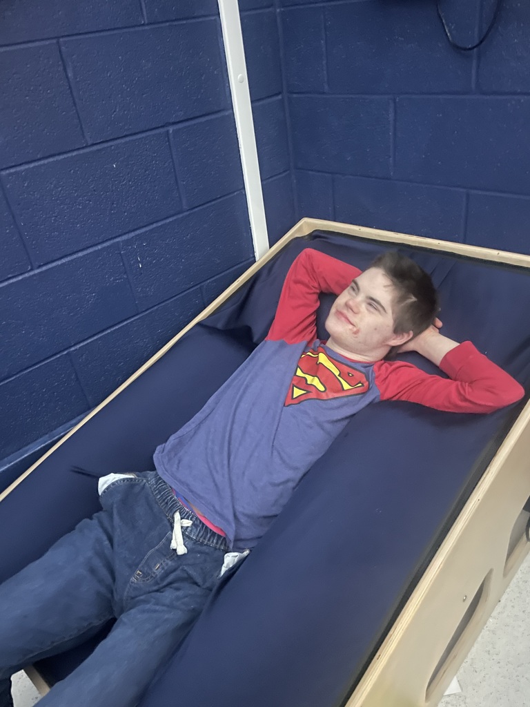 Young man laying back in a lounge chair