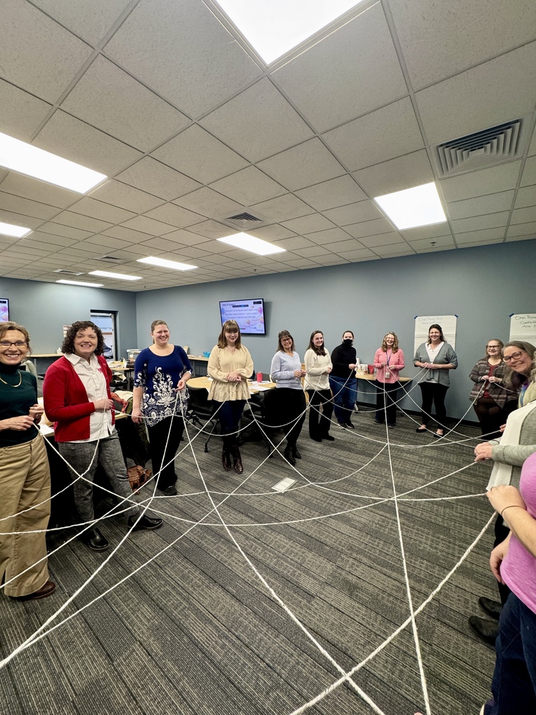 Large group of women all holding a string. 