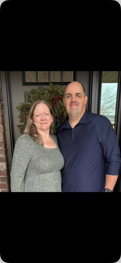 Photo of a woman standing next to a man 
