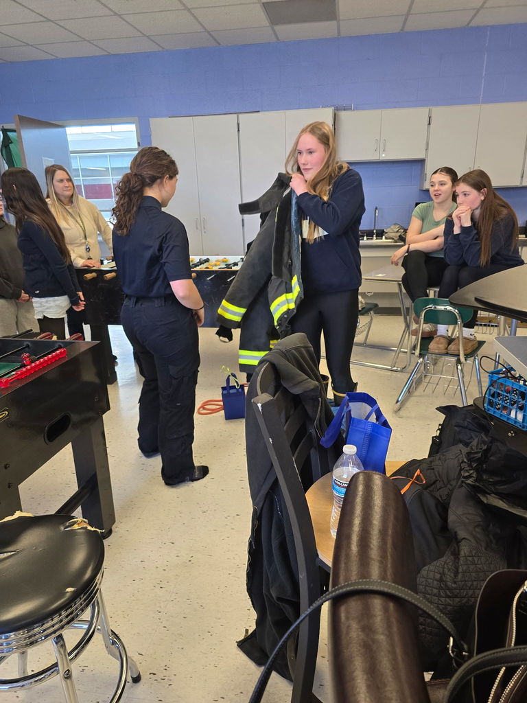 Student putting on firefighter gear