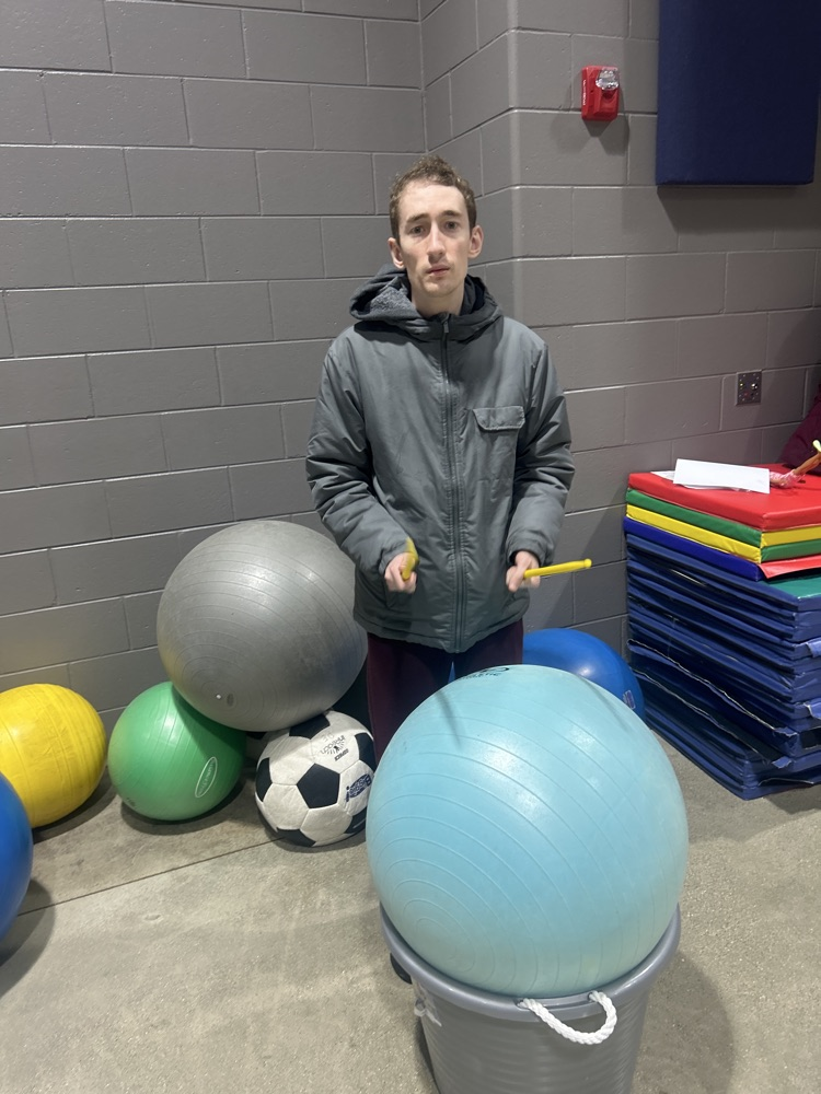 student practicing drumming
