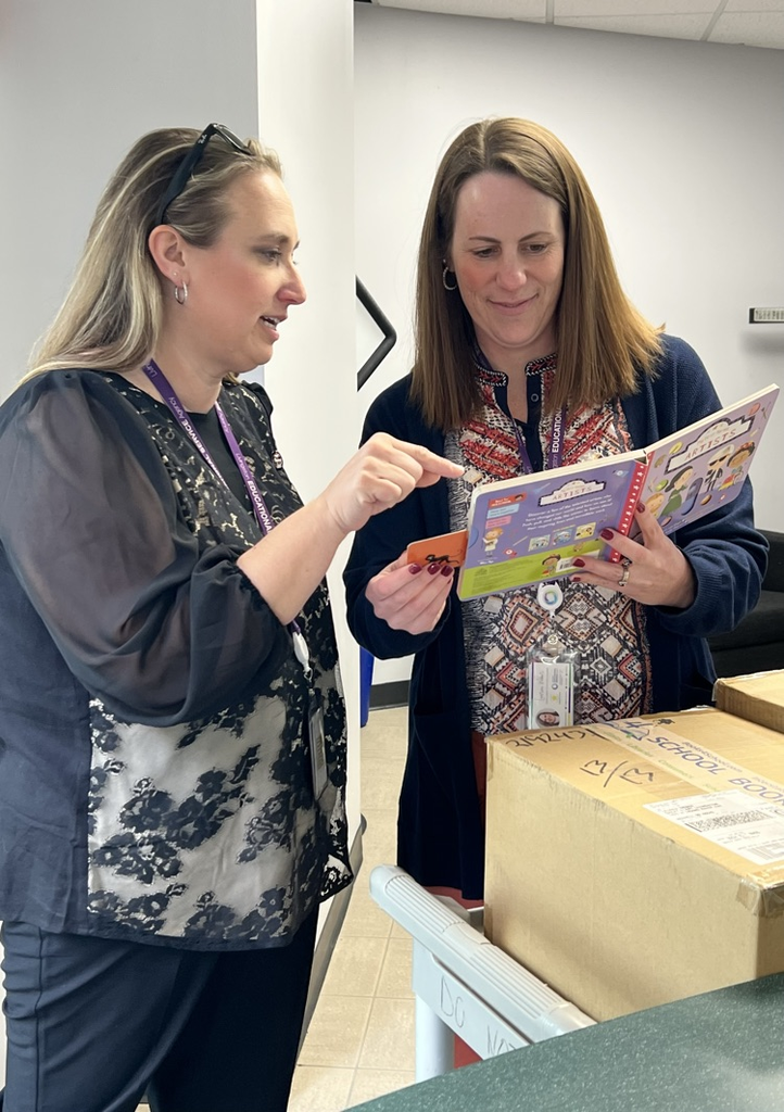 Two women looking over a new book 