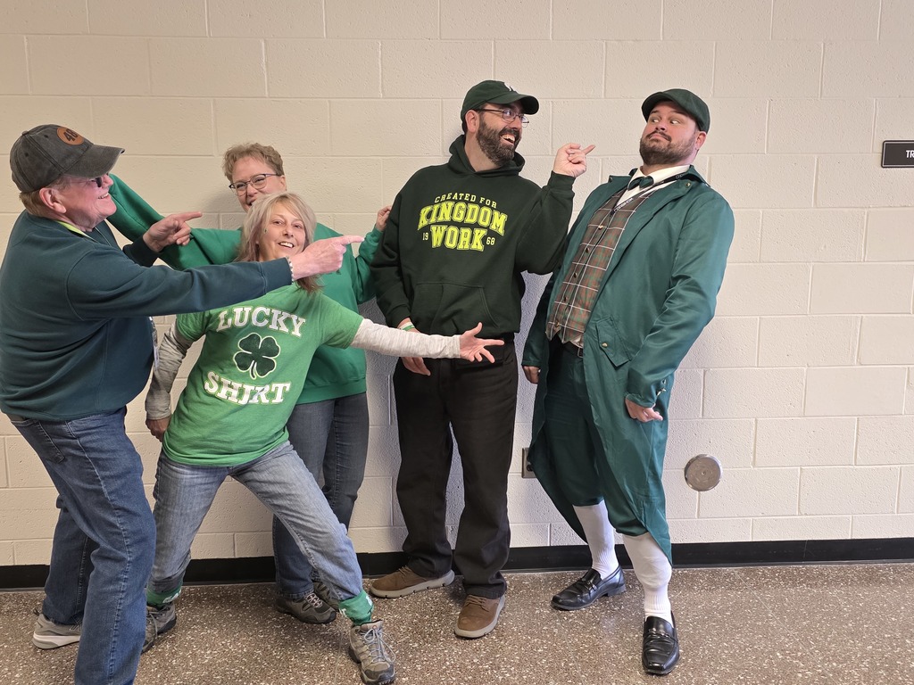 People in green making funny faces