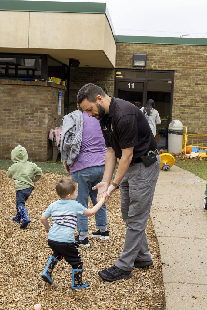 Resource Officer giving a young boy high five