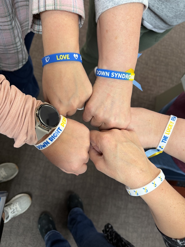 Five hands with wristbands and celebrate Down Syndrome Day