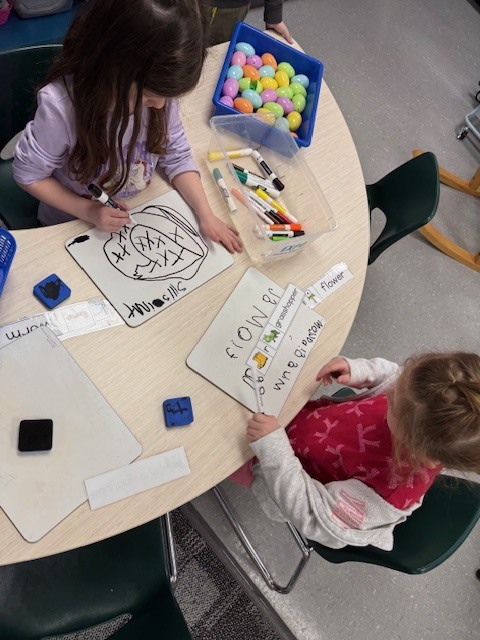 Preschool child working with a writing activity, using materials to practice forming lines and develop early writing skills.