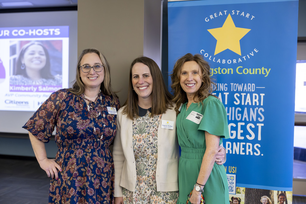Three women pose for photo.