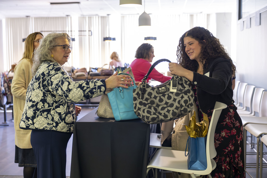 Woman holding purses together. 