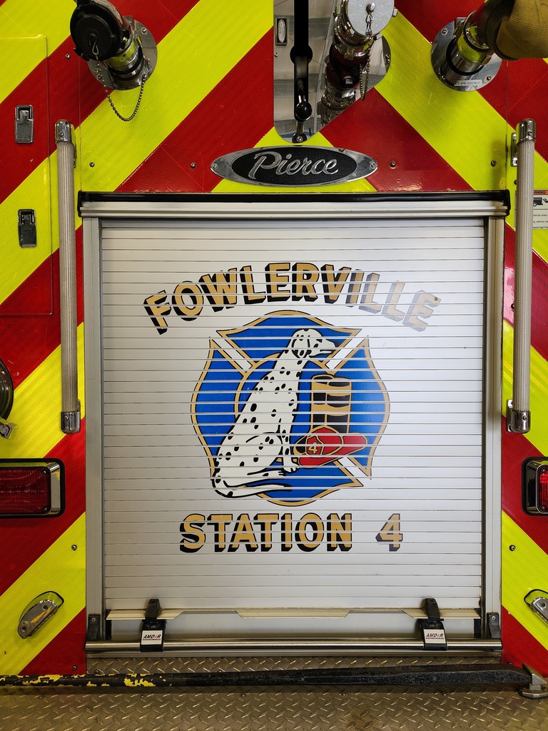 The back of a fire truck with the fire station logo.
