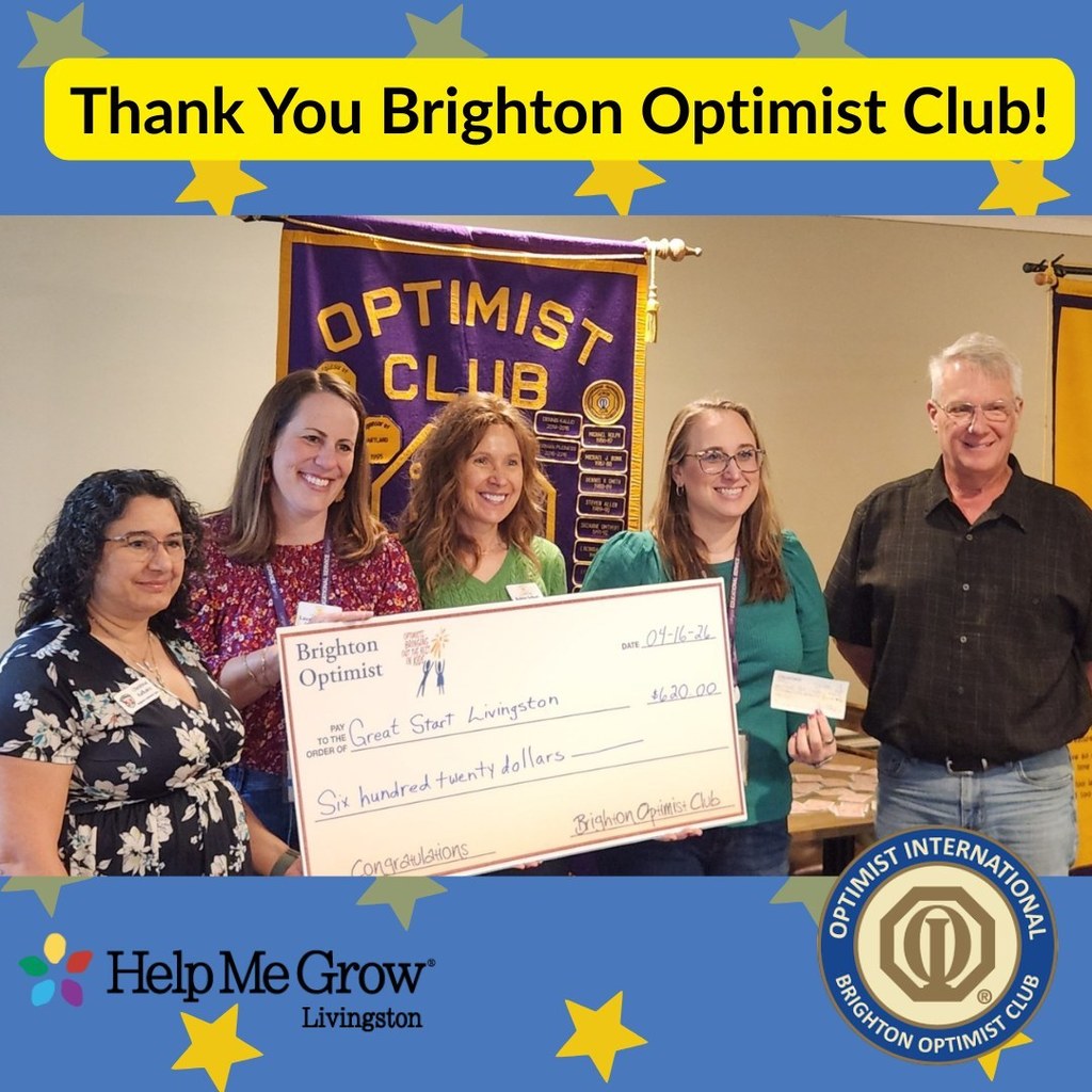Five people stand together holding a big check