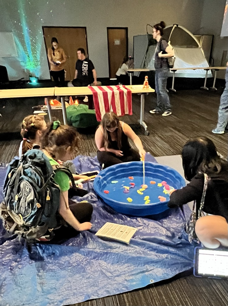 Group of young learners gathered at a kiddy pool 