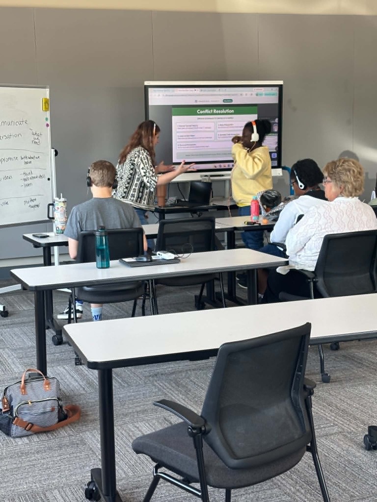 Student and teacher role-playing conflict resolution skills while practicing “I feel” statements during a social skills lesson.