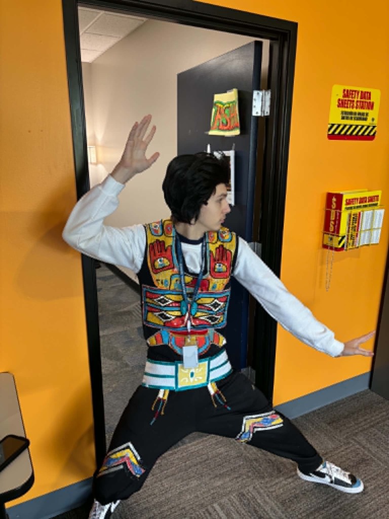 Student dressed as Elvis Presley, posing confidently in costume