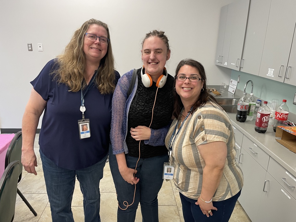 Three adult ladies standing in a kitchen.