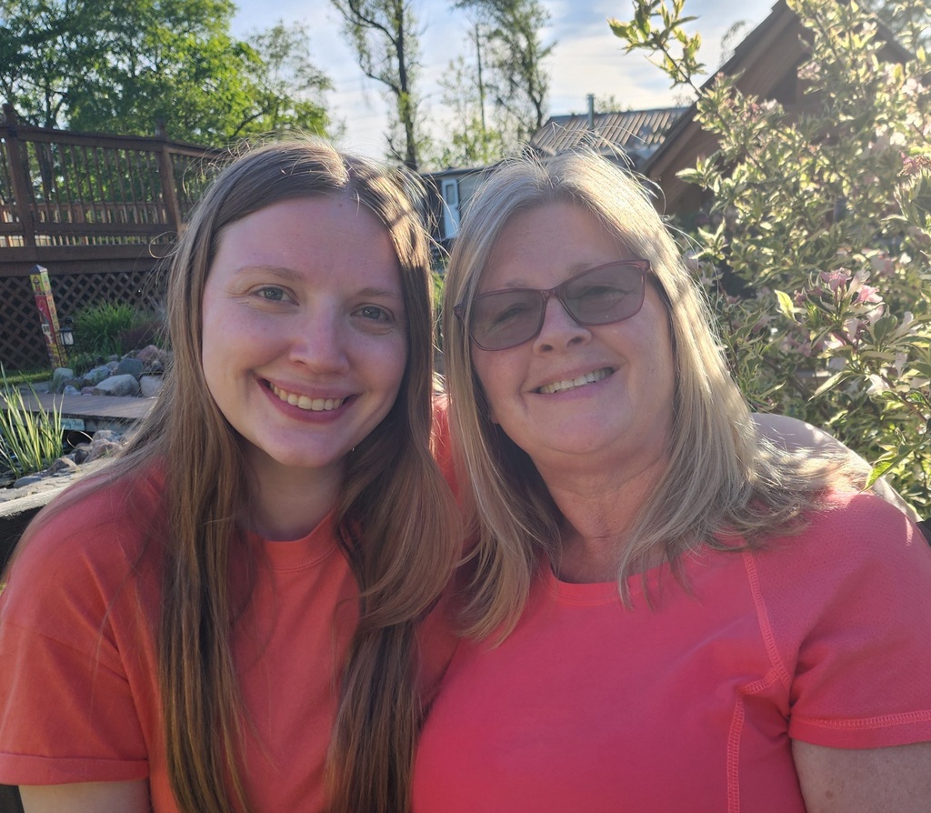 Two ladies smiling.