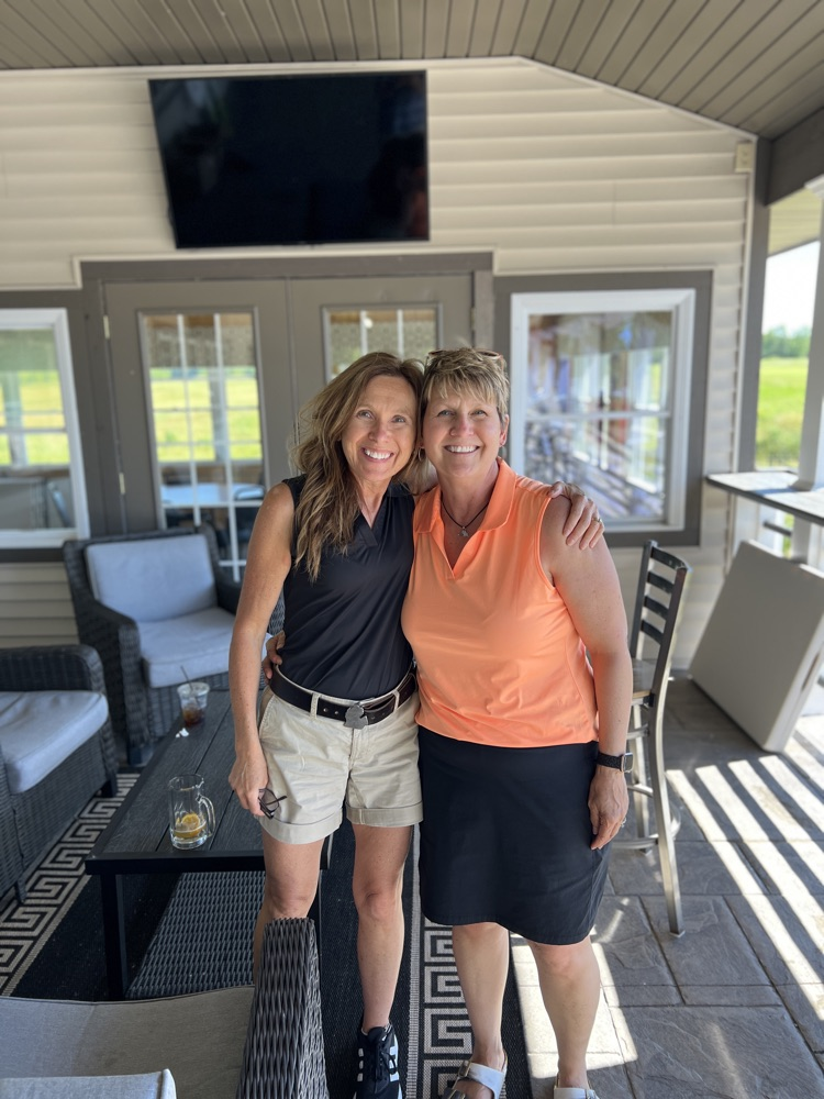 Two women pose for a photo. 