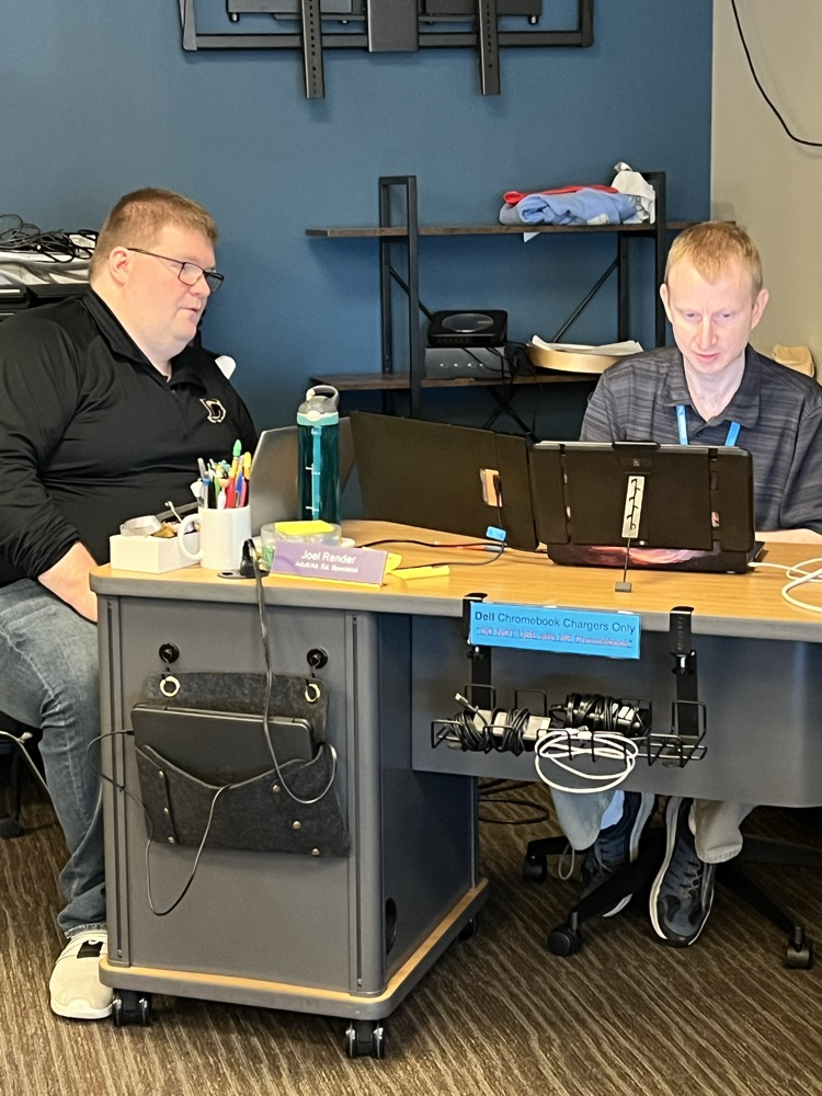 Two men working together to solve a technical issue.