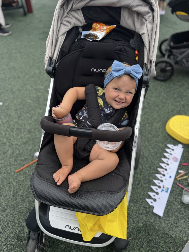 Cute baby sitting in her stroller.