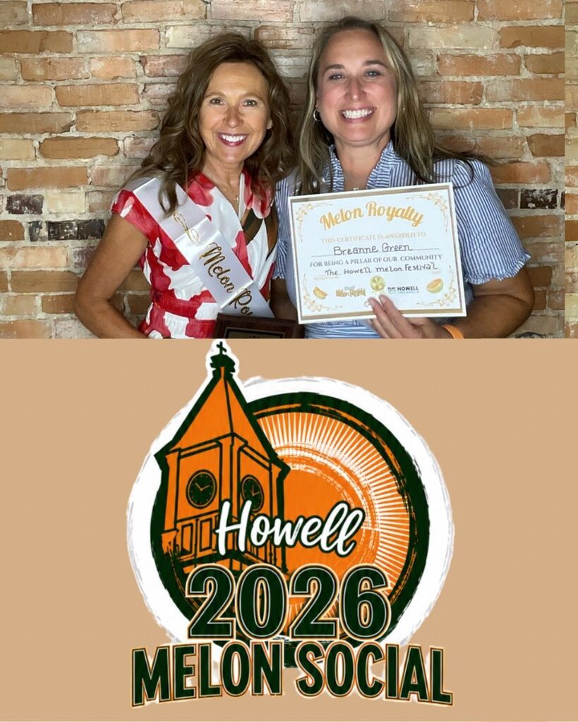 Two women standing together to pose for a photo. One holding a certificate.