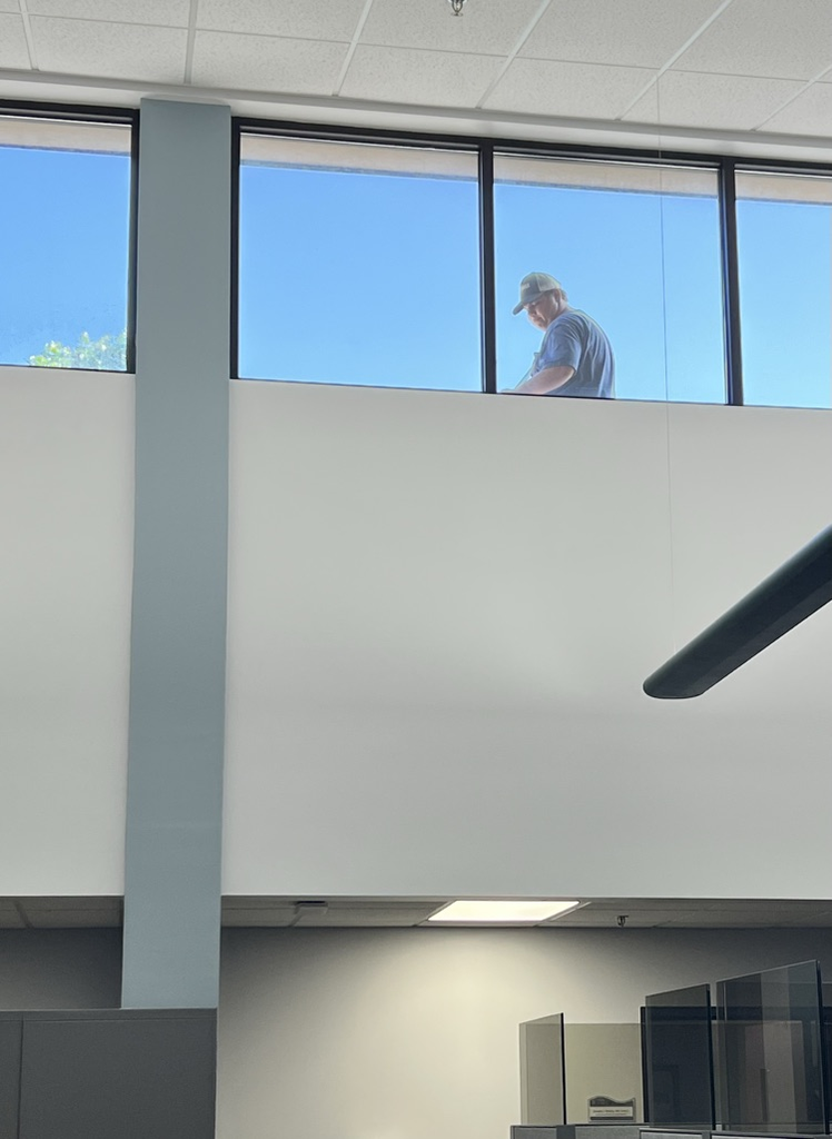 Staff member on roof, clean and painting