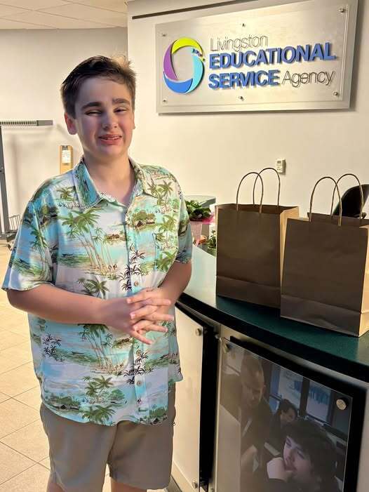 Young man standing in front of LESA sign at the Ed Center