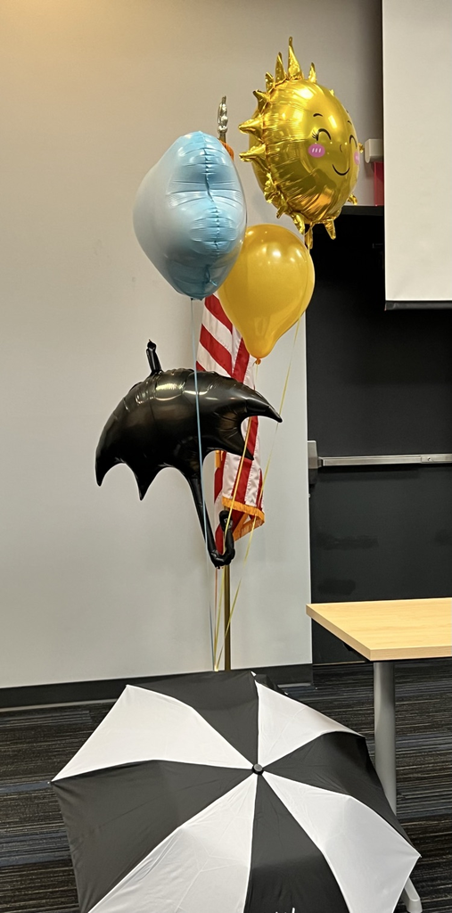 Umbrella with weather balloons attached