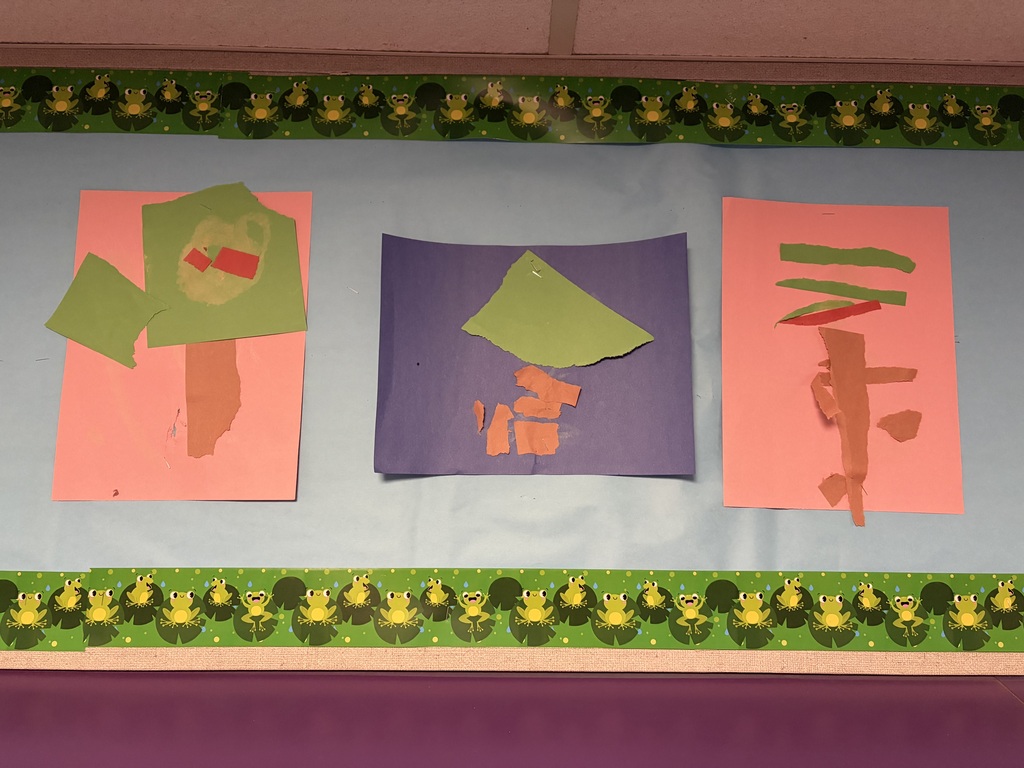Preschool children’s torn-paper tree art displayed on a classroom bulletin board. The colorful creations feature ripped and layered pieces of green, brown, and orange paper on bright backgrounds, showcasing the children’s creativity while developing fine motor skills through ripping, tearing, and sticking paper.