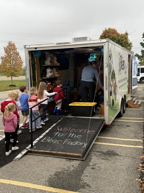 GSRP students line up to enter The Bear Factory mobile trailer for an on-site field trip.