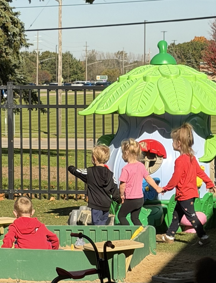 Children playing outside on the playground.