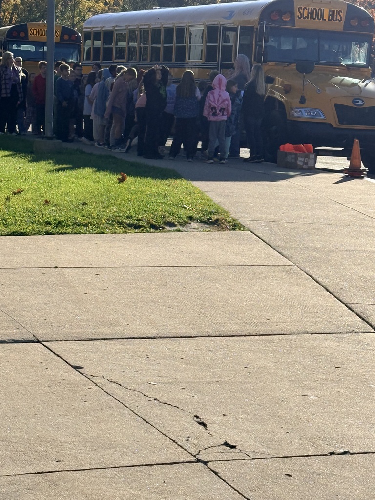 School bus with students around it 